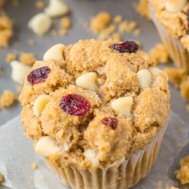 Moist, light and fluffy on the inside, you won't believe these flourless white chocolate cranberry muffins have NO butter, oil, eggs or refined sugar in them! {vegan, gluten free recipe}