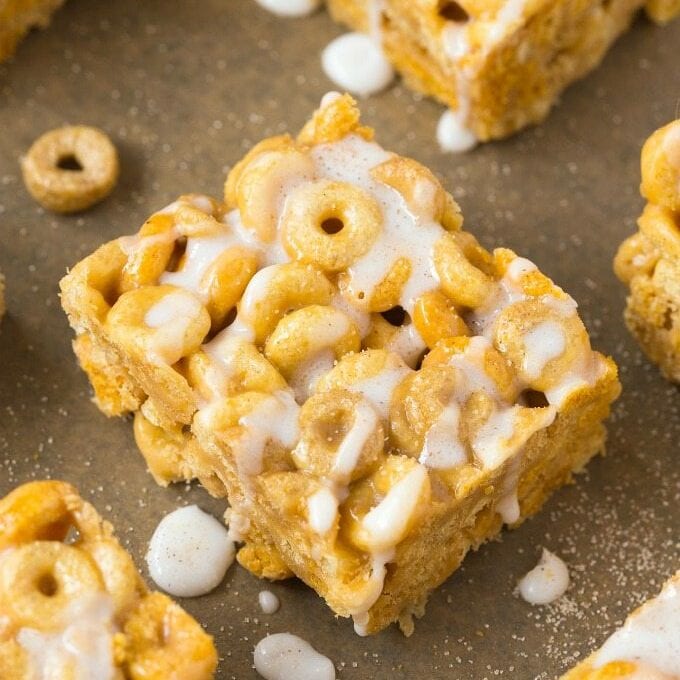 Cinnamon roll protein cereal bars topped with cinnamon drizzle