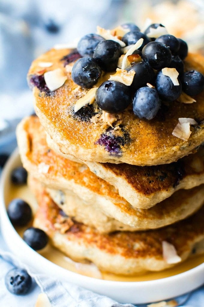 Thick + Fluffy Flourless Blueberry Smoothie Pancakes (V, GF, DF)- Egg-free and healthy blender pancakes made in minutes- Protein-packed, low carb, low calorie and sugar free! {vegan, gluten free, egg-free recipe}- thebigmansworld.com