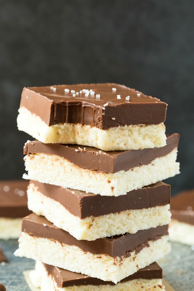 Healthy 4-Ingredient Paleo Vegan Chocolate Coconut Bars stacked on top of one another