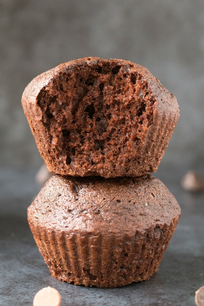 Healthy Flourless Pumpkin Chocolate Muffins stacked on top of one another.