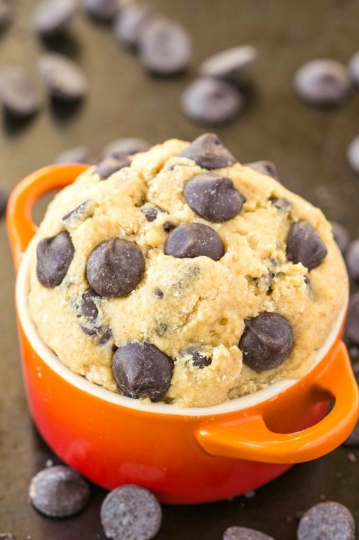 A bowl of healthy cookie dough for one topped with chocolate chips.
