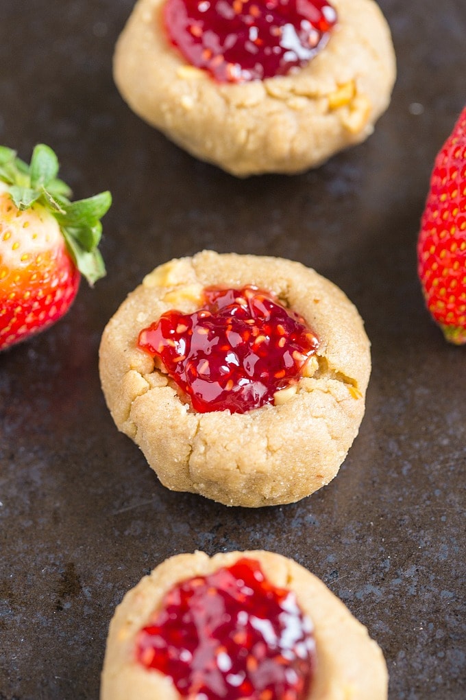 Soft and chewy keto vegan thumbprint cookies filled with raspberry jam