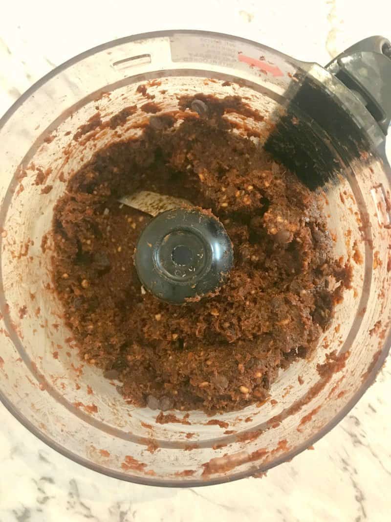 Food processor with brownies with dates, almonds and walnuts