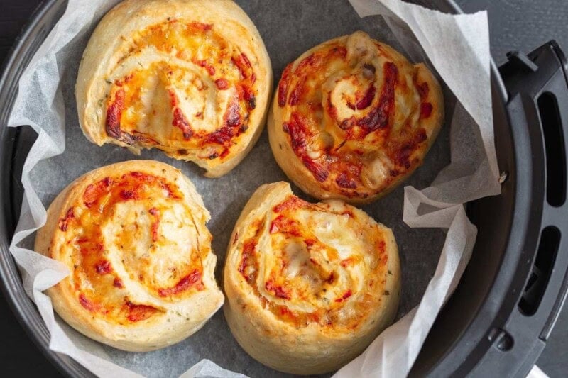 pizza rolls in air fryer basket.