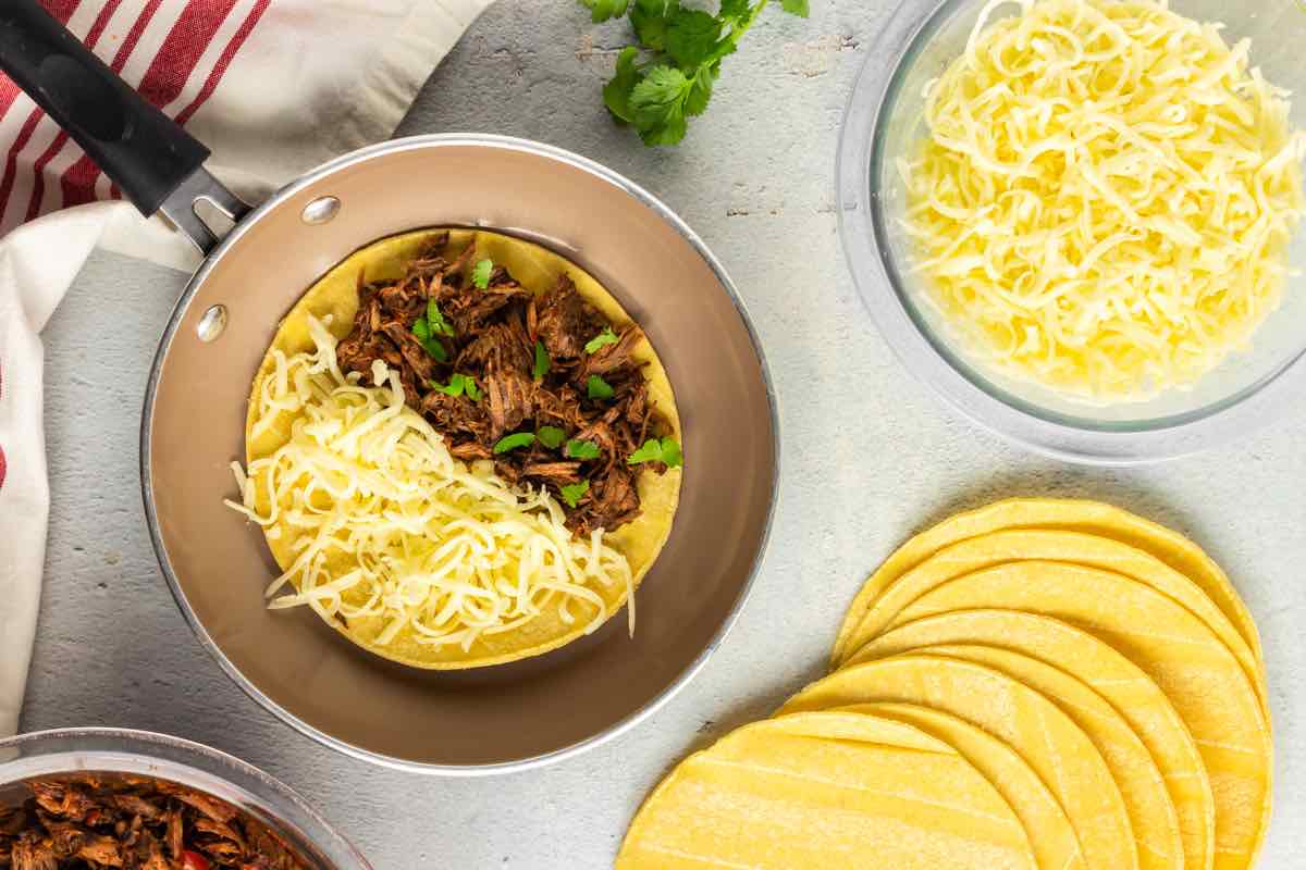 soaked tortillas on a skillet.