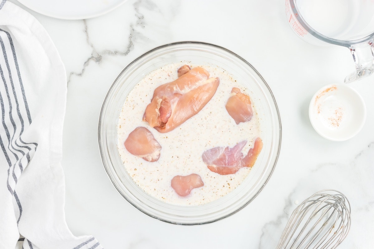 chicken marinating in buttermilk.