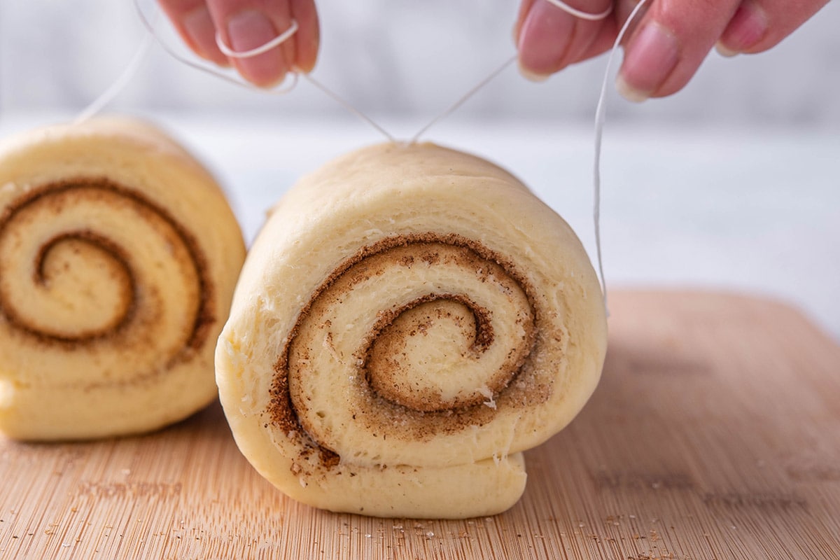 cutting cinnamon rolls.