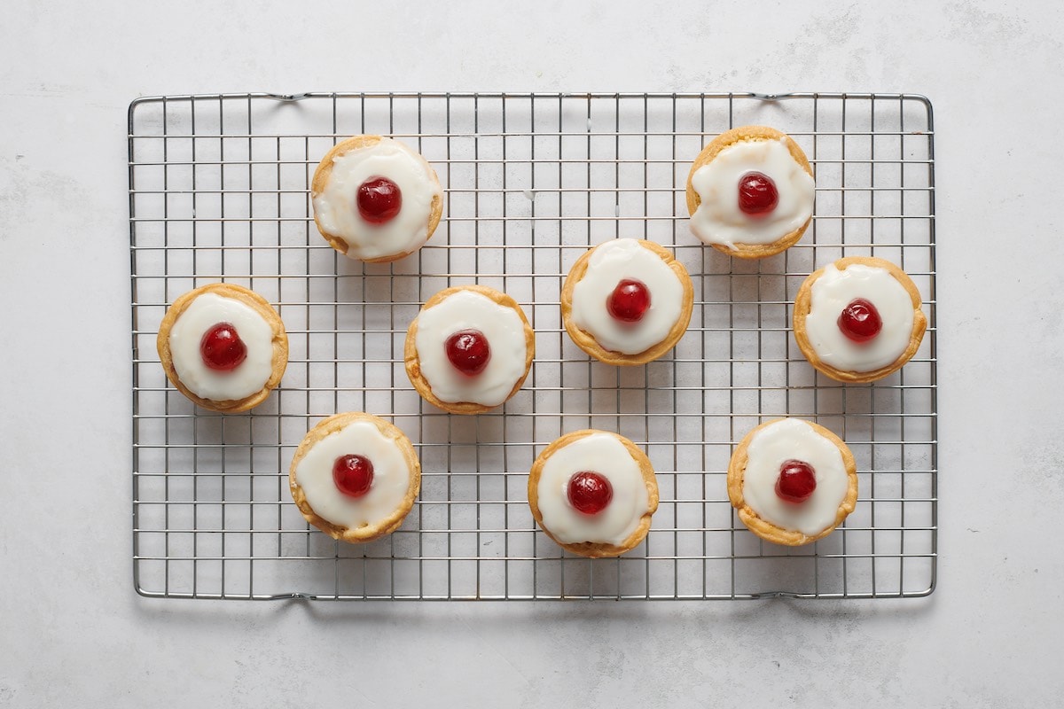 tarts with icing and cherry.