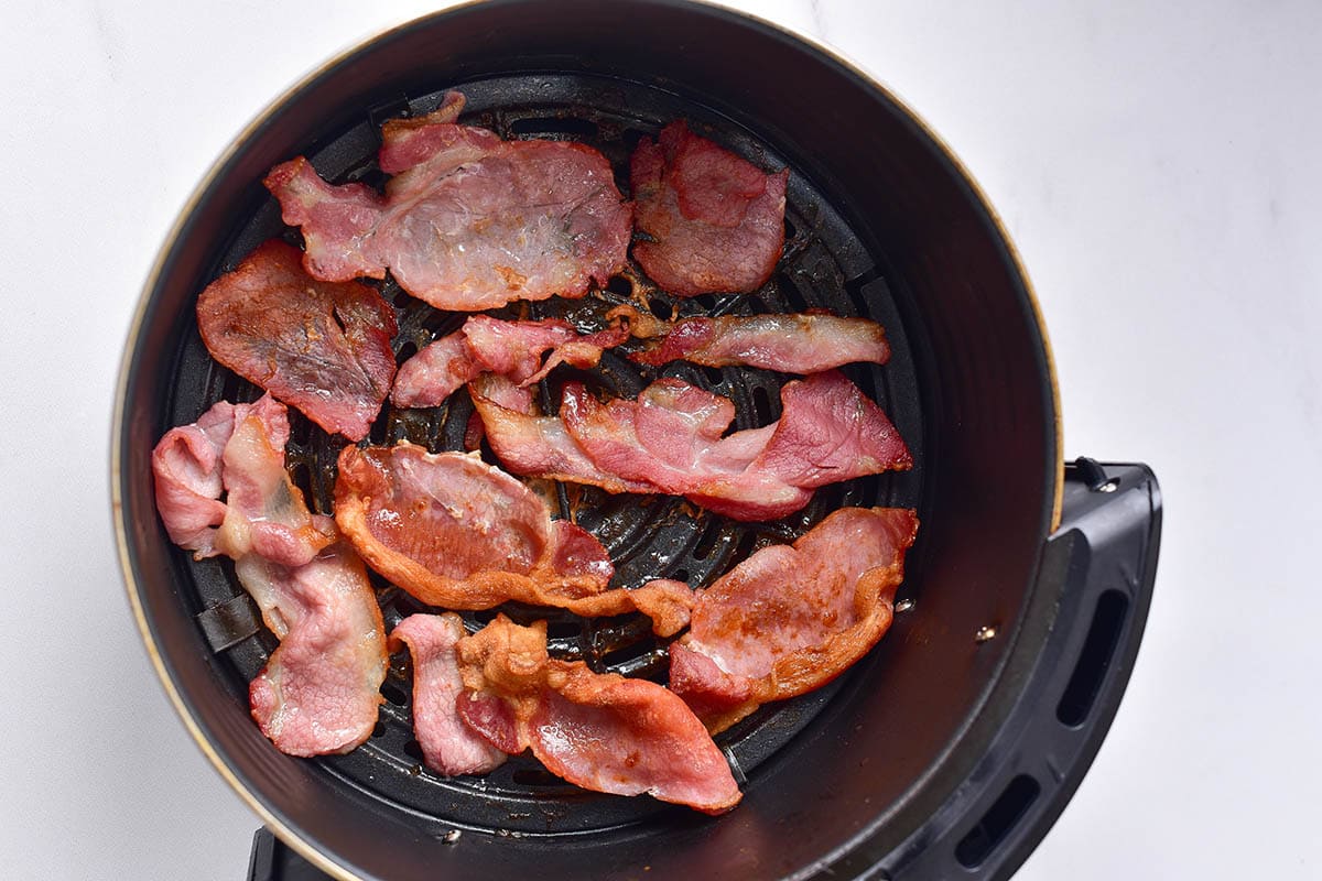 bacon in air fryer basket.