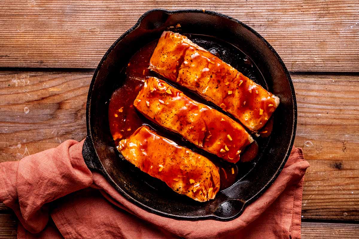 salmon in skillet with firecracker sauce.