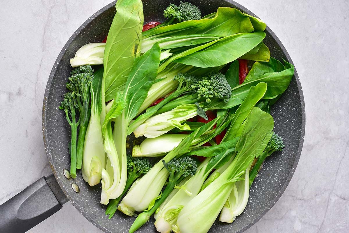 stir frying bok choy.