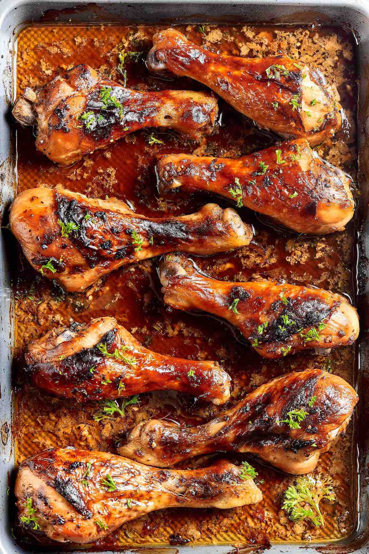 oven baked chicken legs on tray.