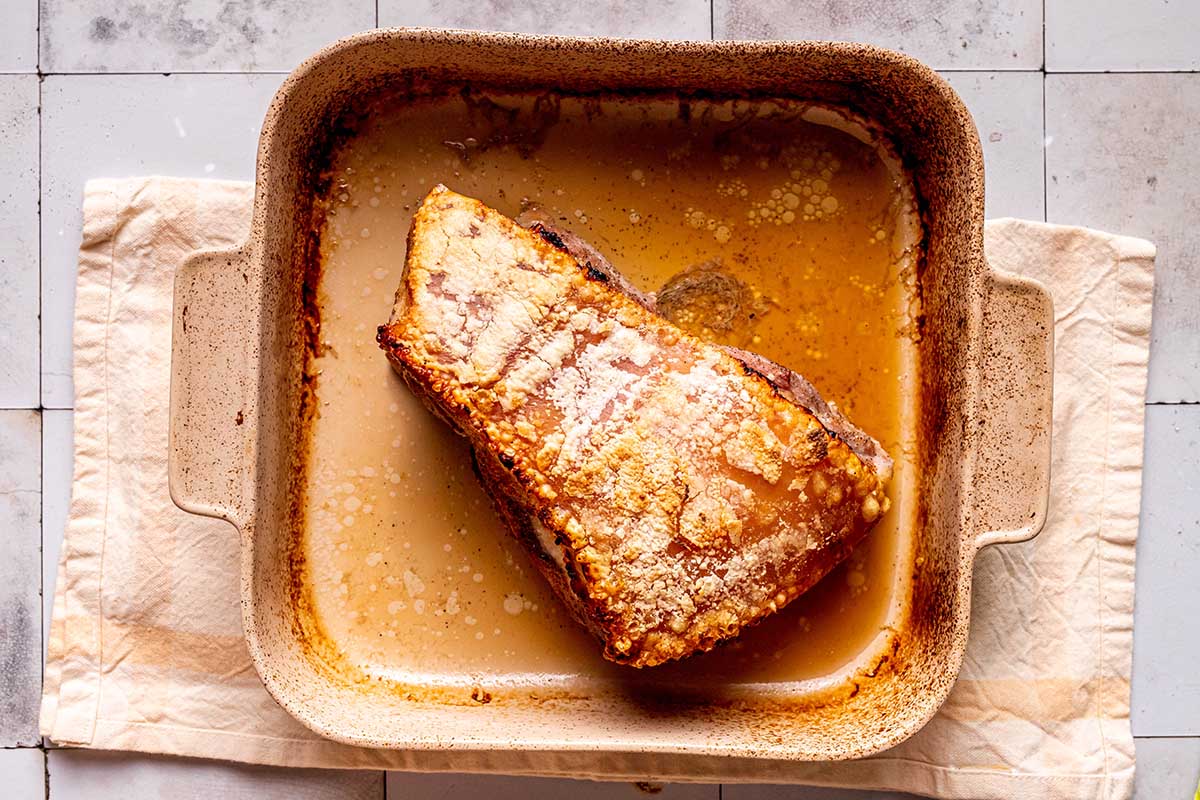 broiled pork belly in roasting pan.