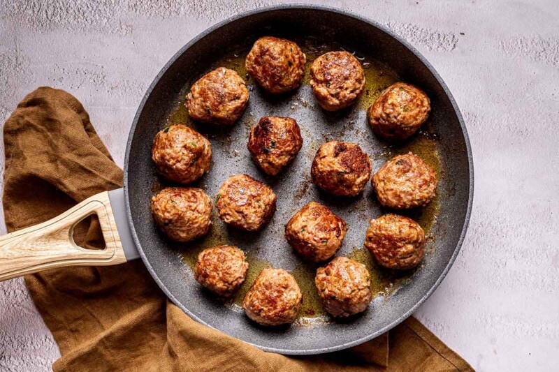 browned meatballs in skillet.