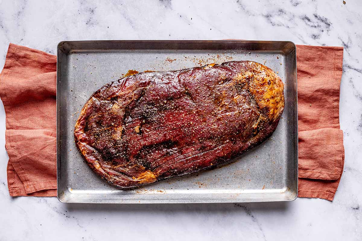 seasoned steak on tray.