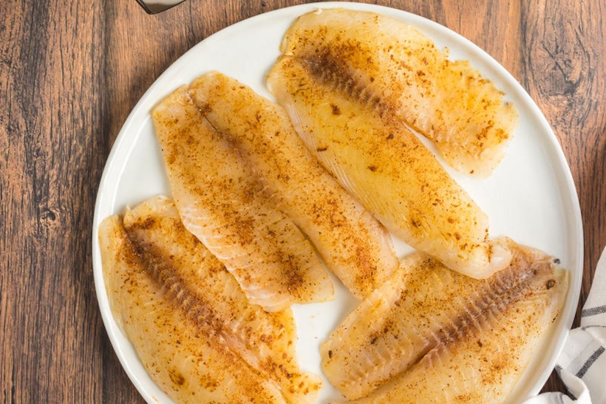 seasoned raw tilapia fillets.