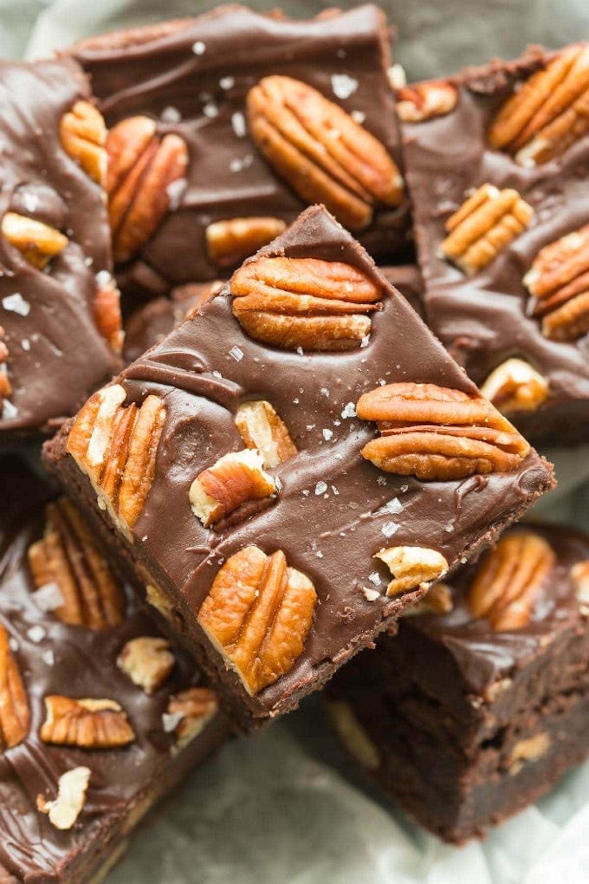pecan brownie recipe with chocolate frosting and pecans on top.