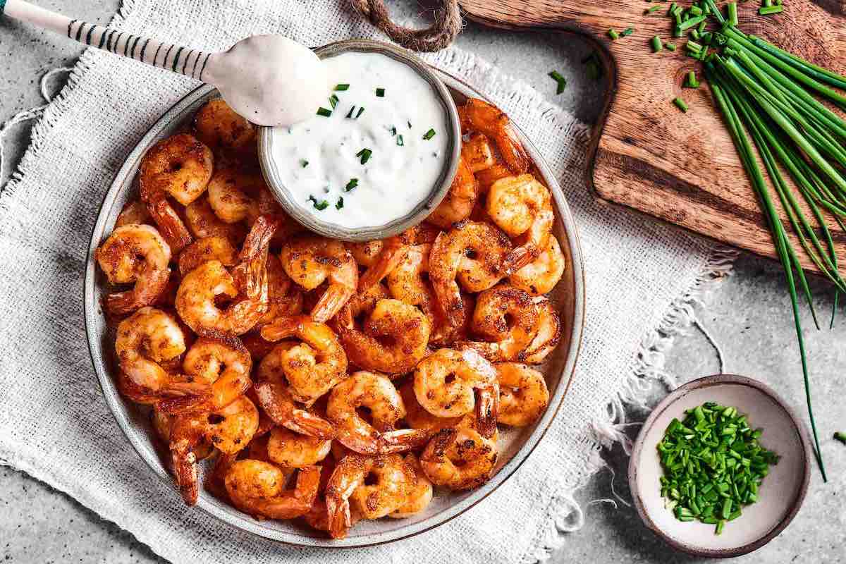 cooked juicy air fried shrimp with garlic yogurt sauce.