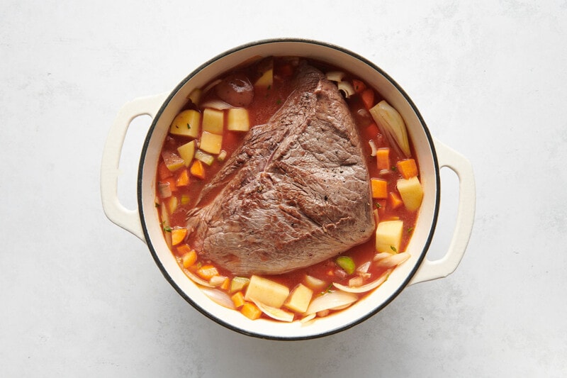 beef and vegetables in Dutch oven.
