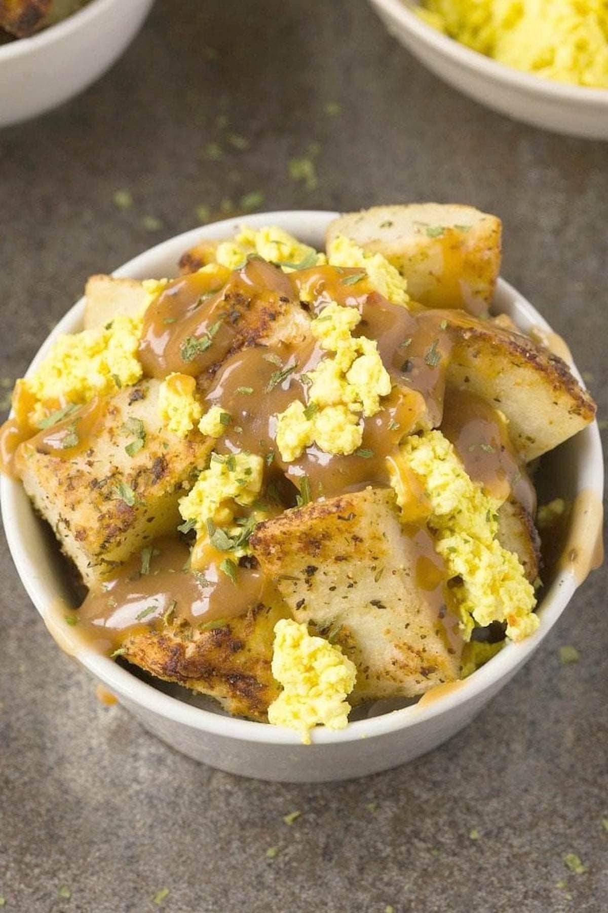 roasted potatoes with crumbled tofu 'curds' and gravy.