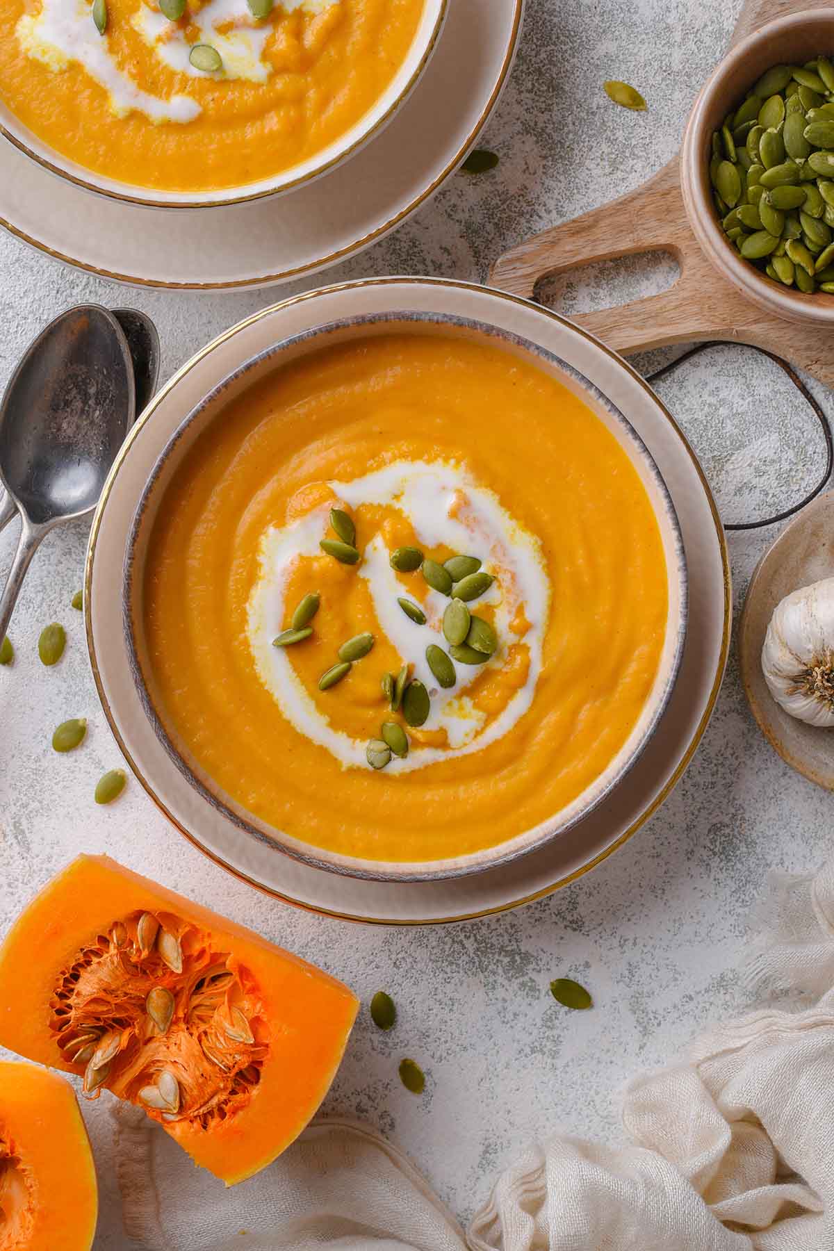 buttercup squash soup in bowl with cream.