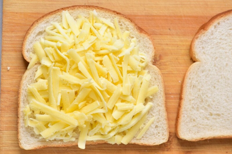 shredded mozzarella and tasty cheese on bread.