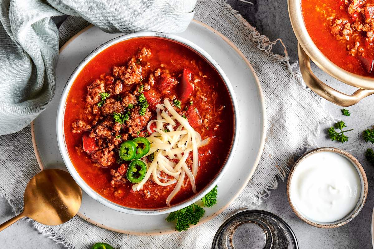 no bean chili with shredded cheese on top. 