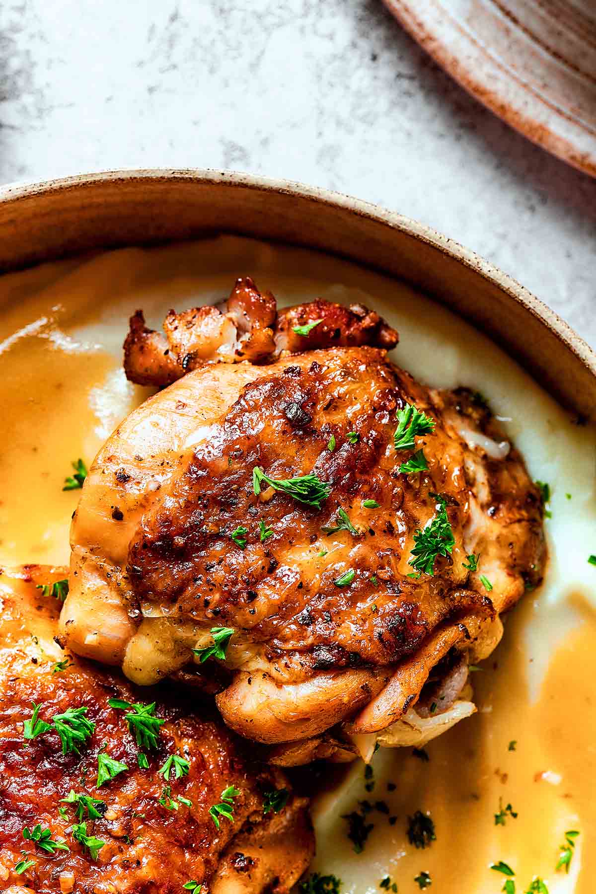 instant pot chicken thigh recipe with fresh herbs on top.