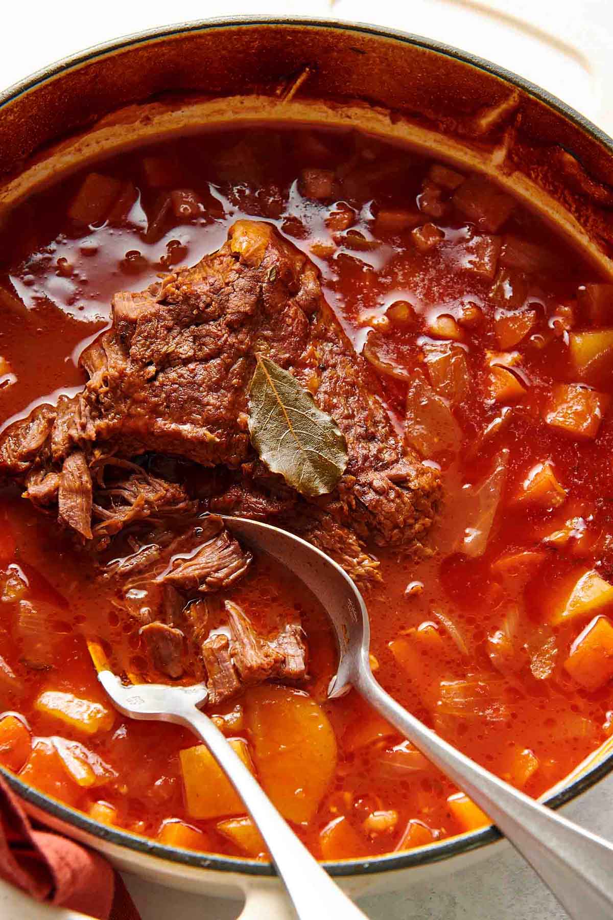 Dutch oven pot roast with shredded meat and broth.