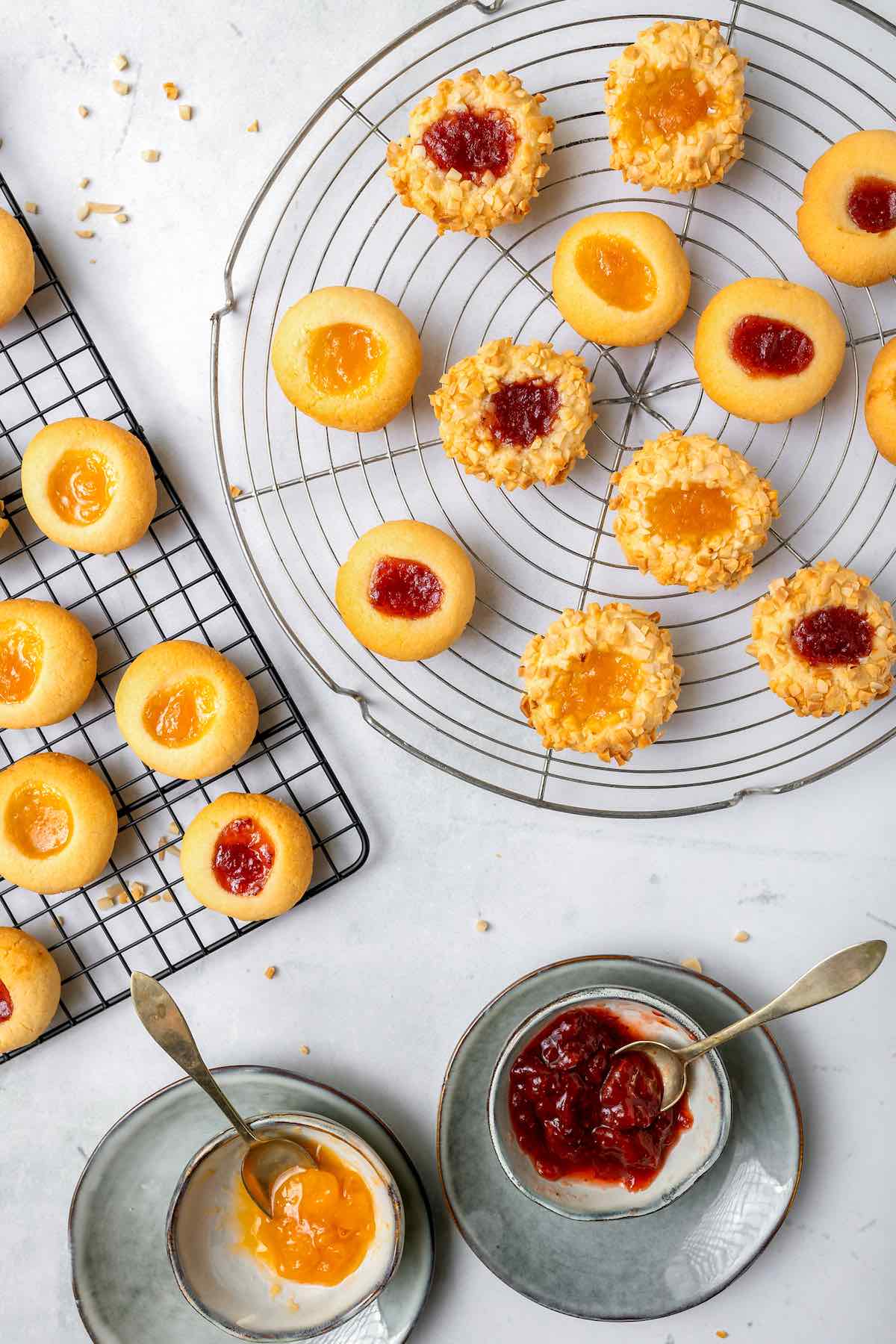 raspberry thumbprint cookies on a baking rack.
