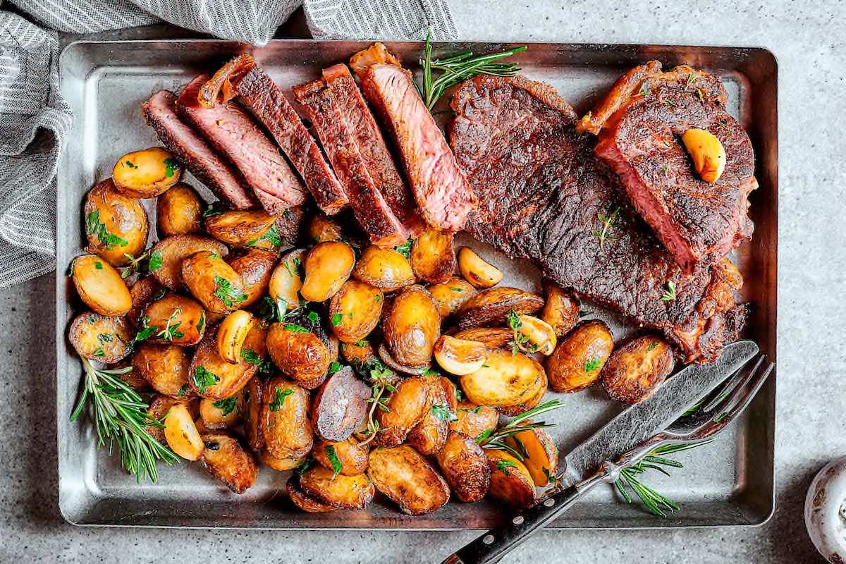 cooked strip steak with potatoes.