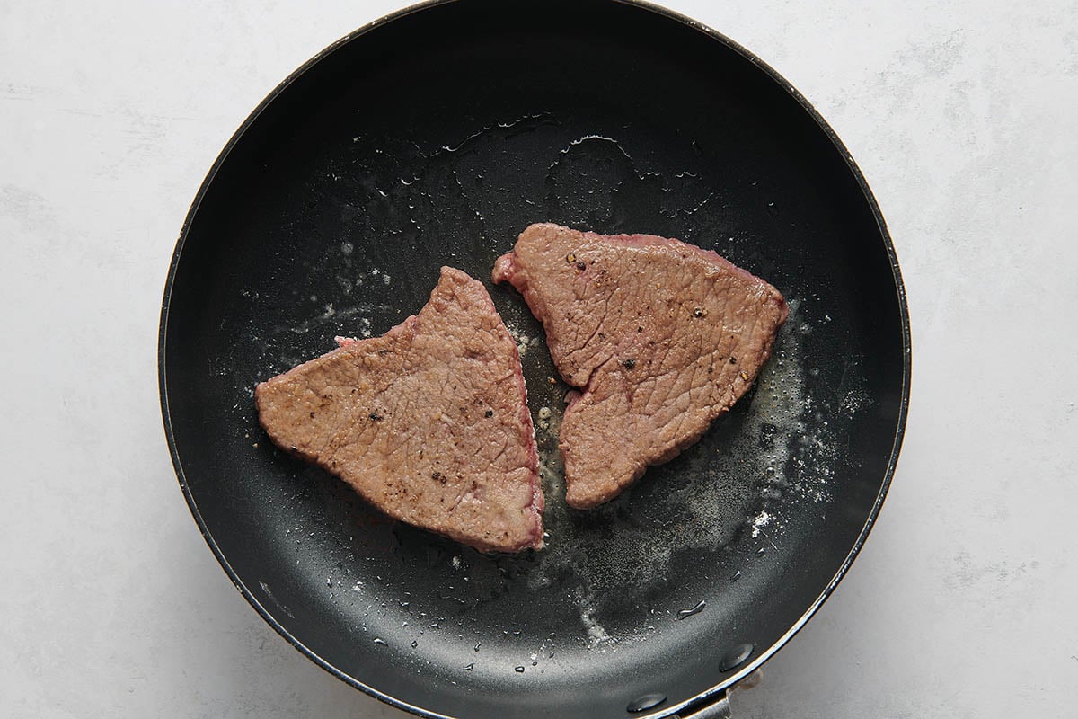 pan fried cube steak in skillet.