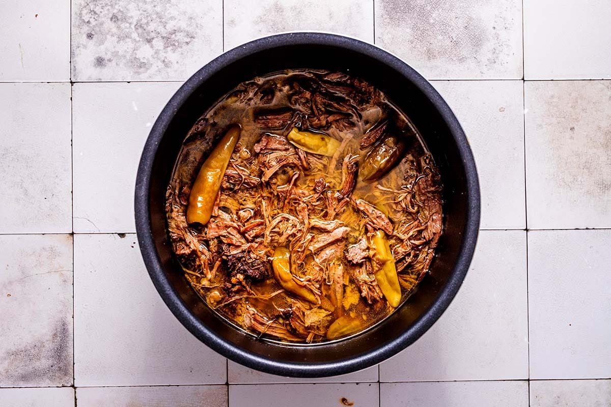 shredded meat and peppers in slow cooker.