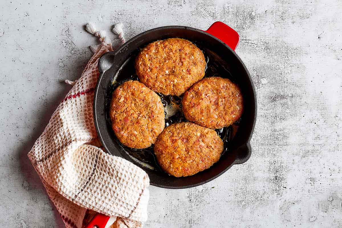 steak patties in skillet.