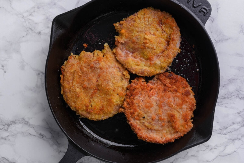 fried veal cutlets in skillet.