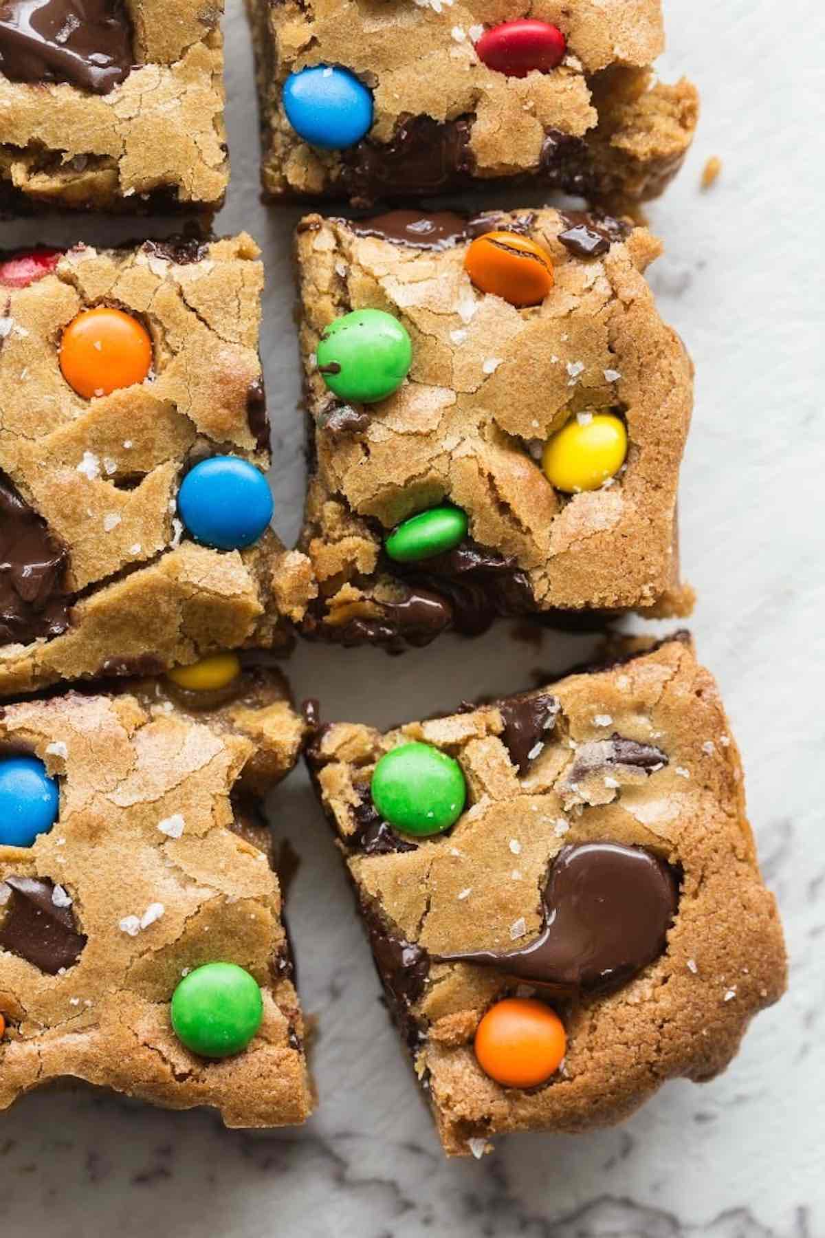 monster cookie bars with candy buttons on top.