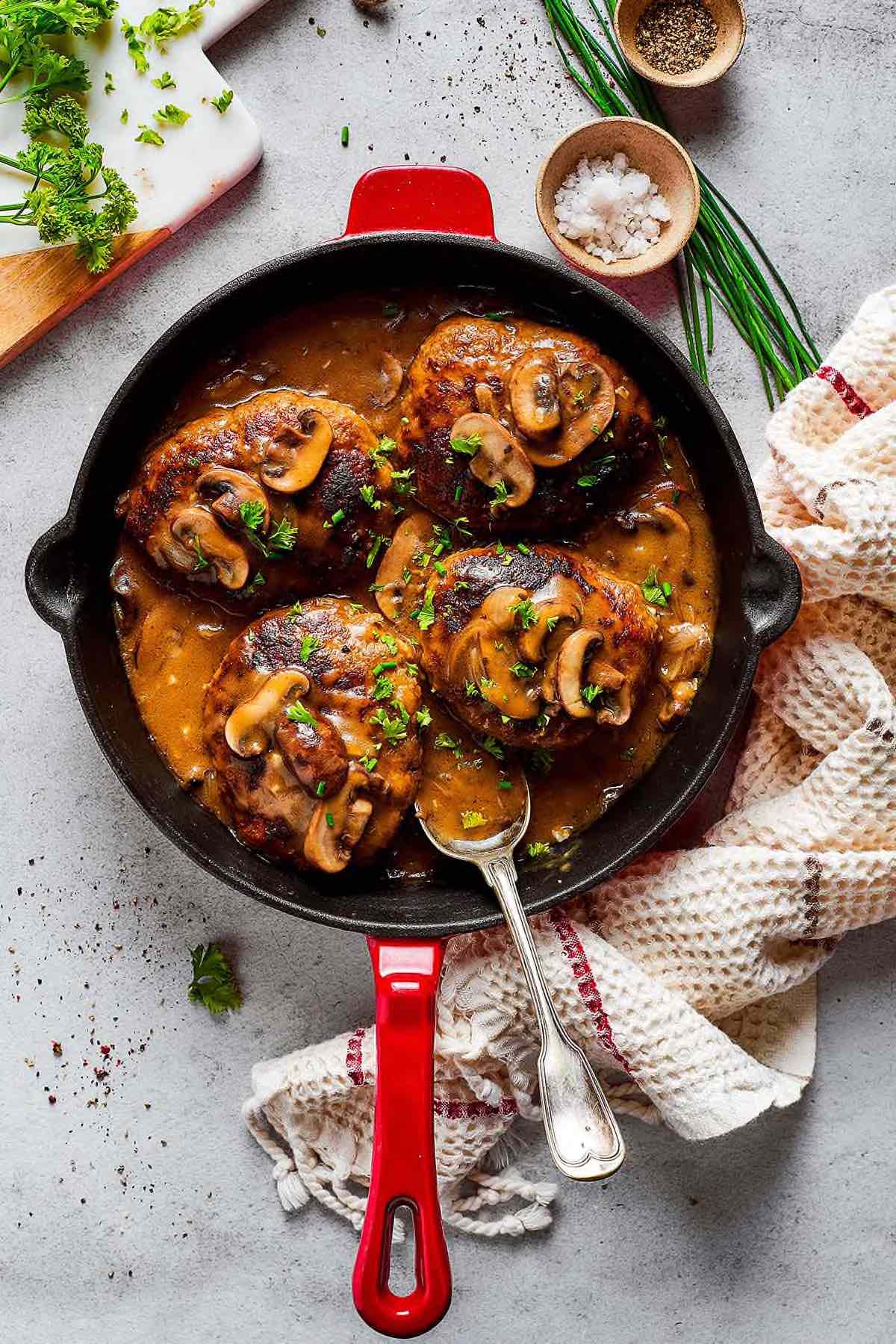 skillet with salisbury steak and gravy.