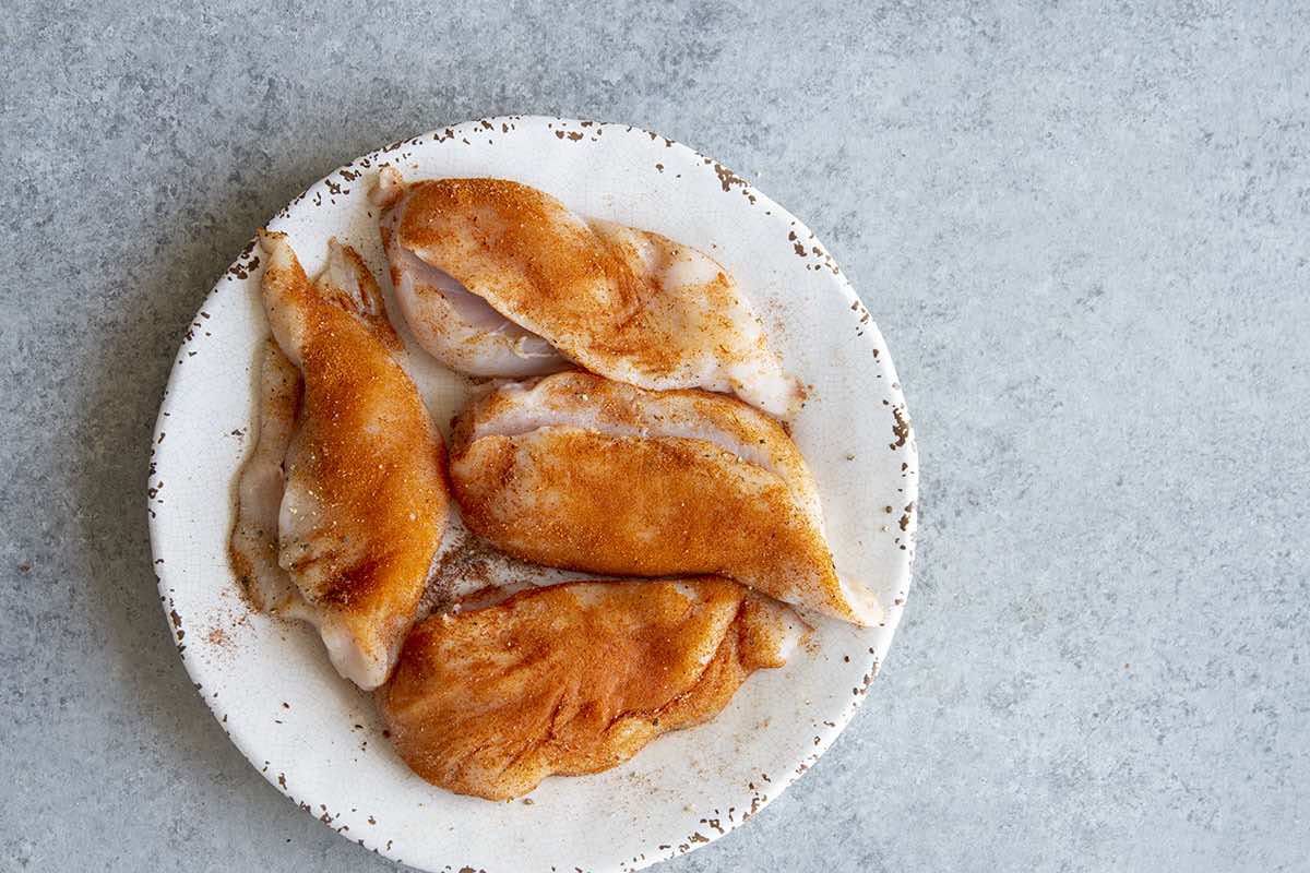 seasoned and stuffed raw chicken breasts.