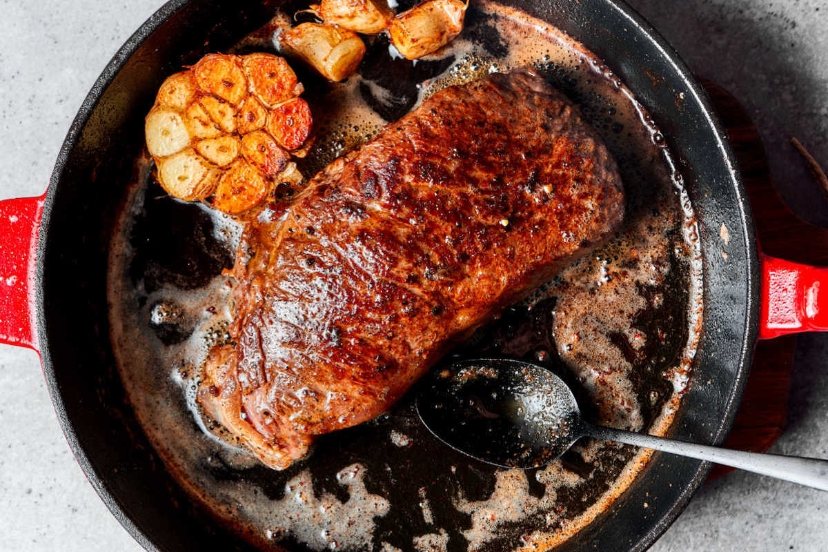 ribeye steak in skillet.