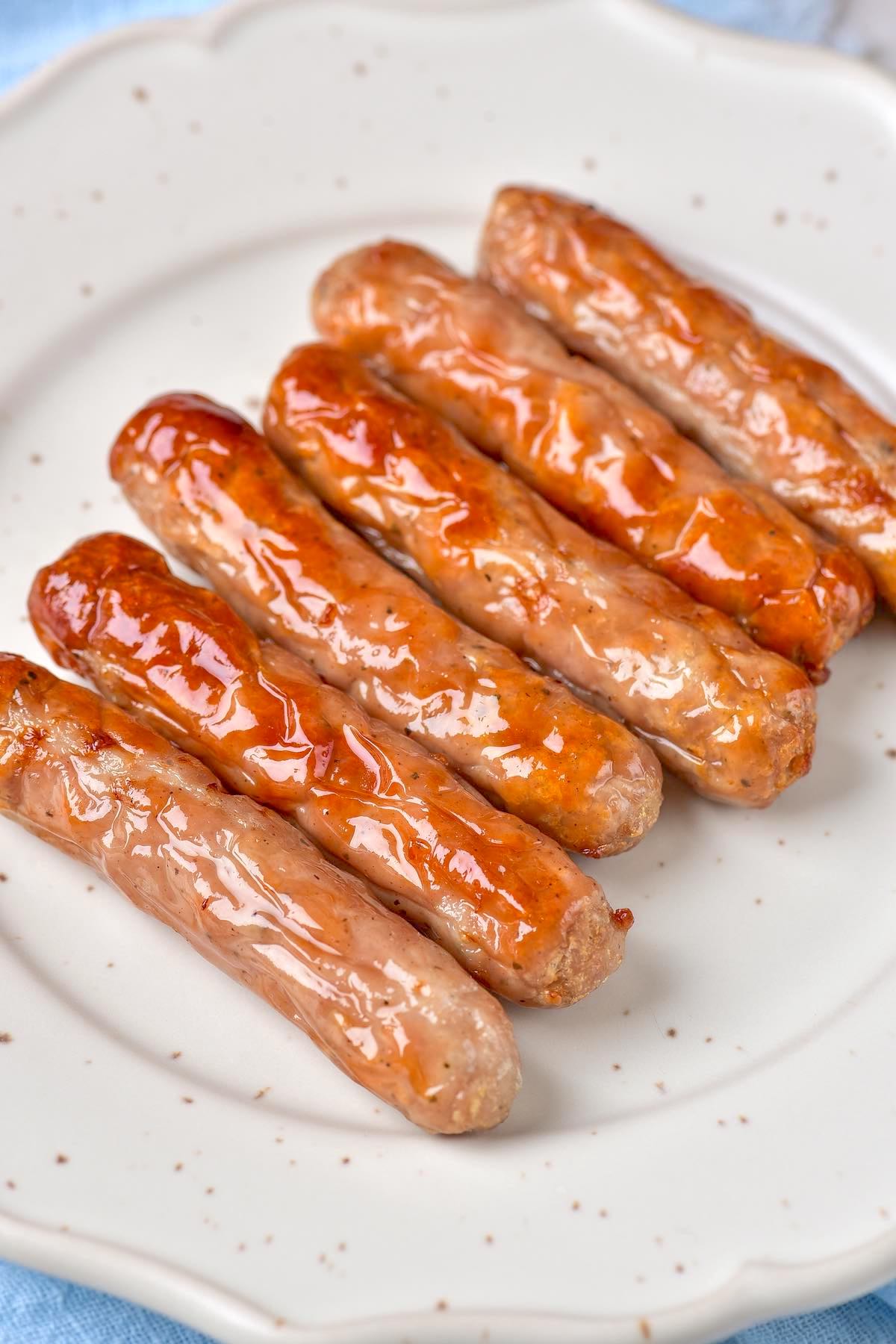 air fryer sausage links on a plate. 