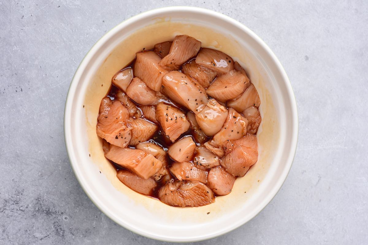 raw chicken soaking in marinade.