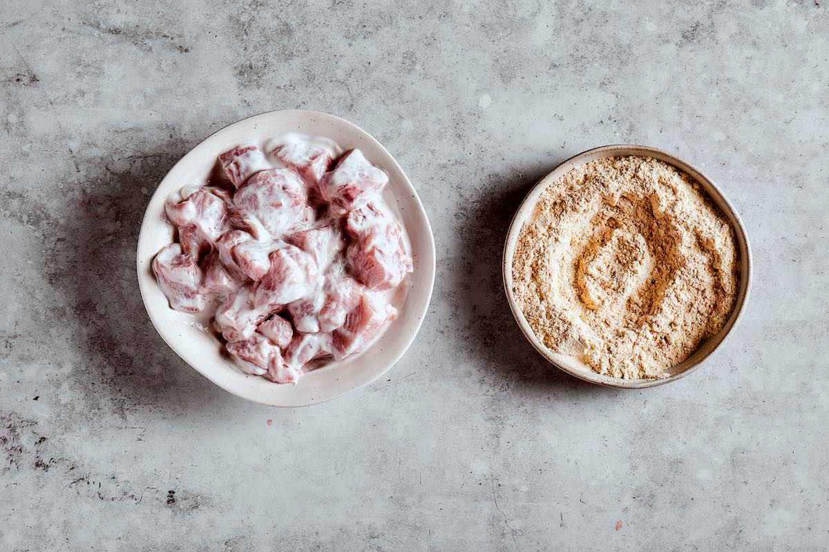 raw chicken marinating in buttermilk.