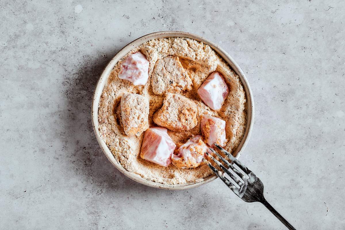 seasoned raw chicken in flour mix.