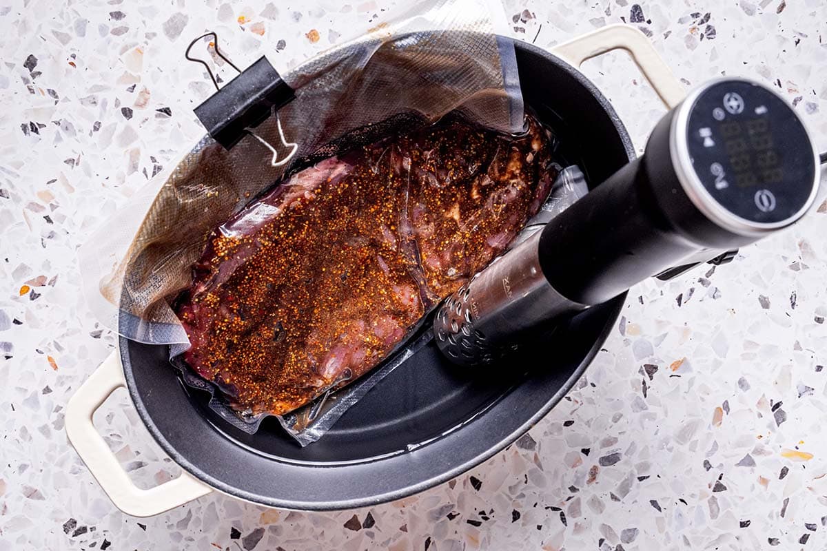 flank steak in vacuum seal in sous vide machine.