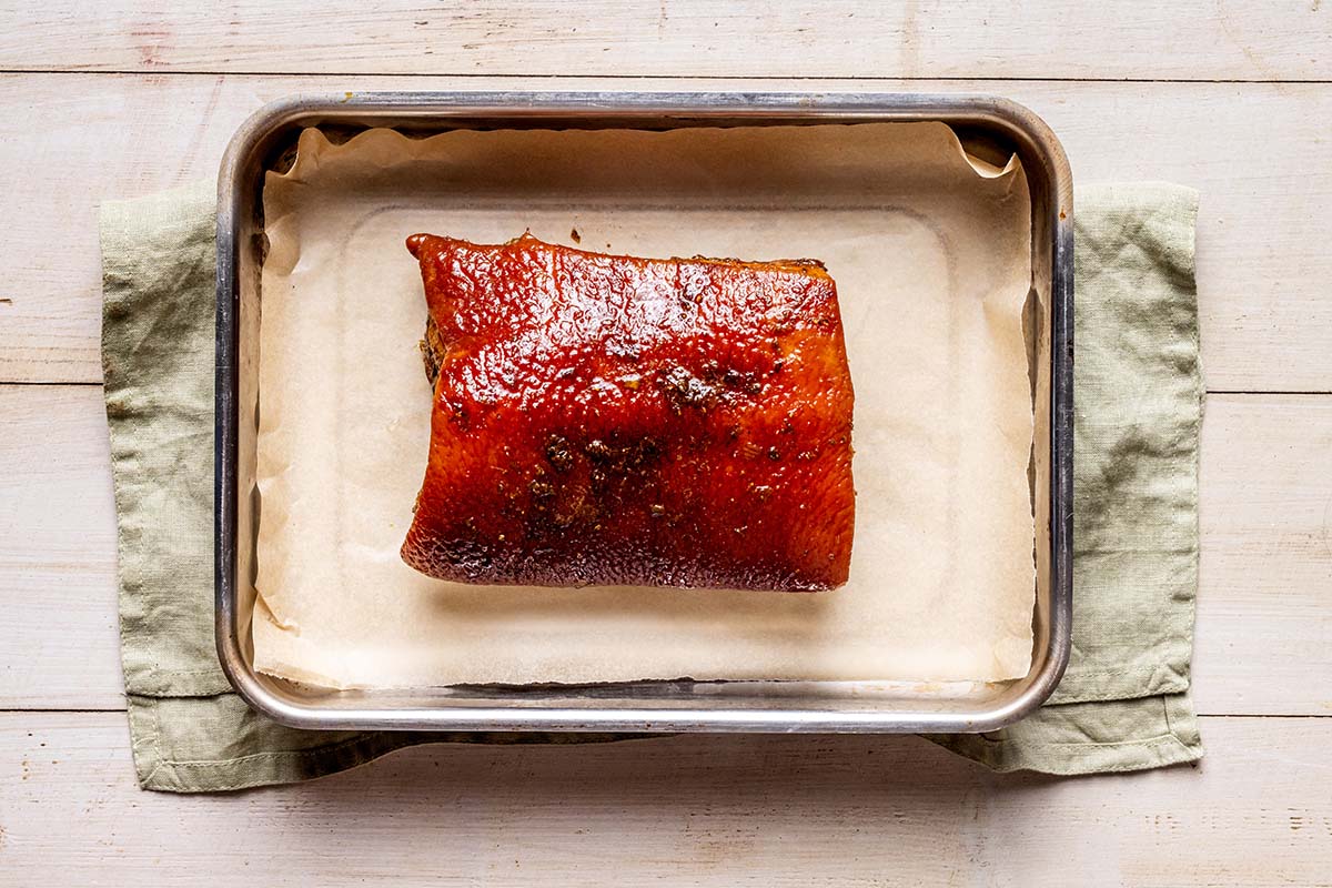 cooked pork belly on baking sheet.