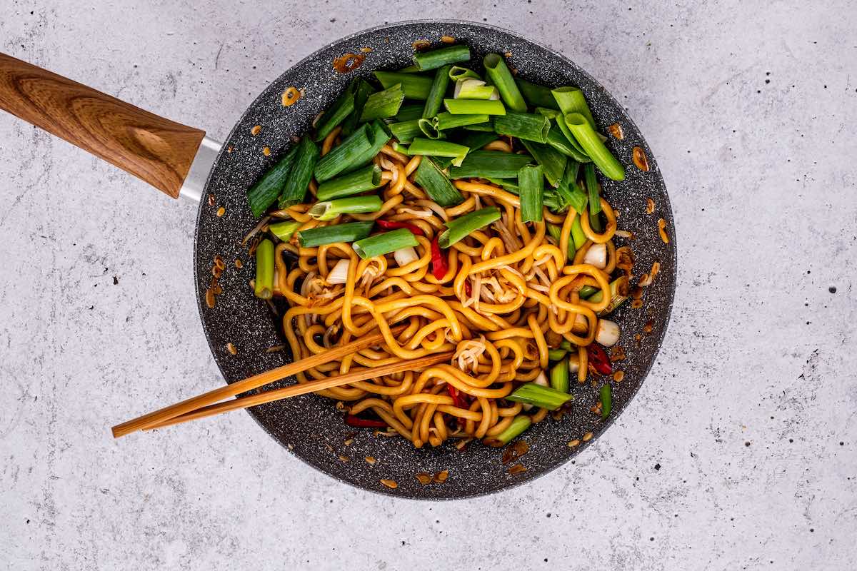 noodles and vegetables in pan.