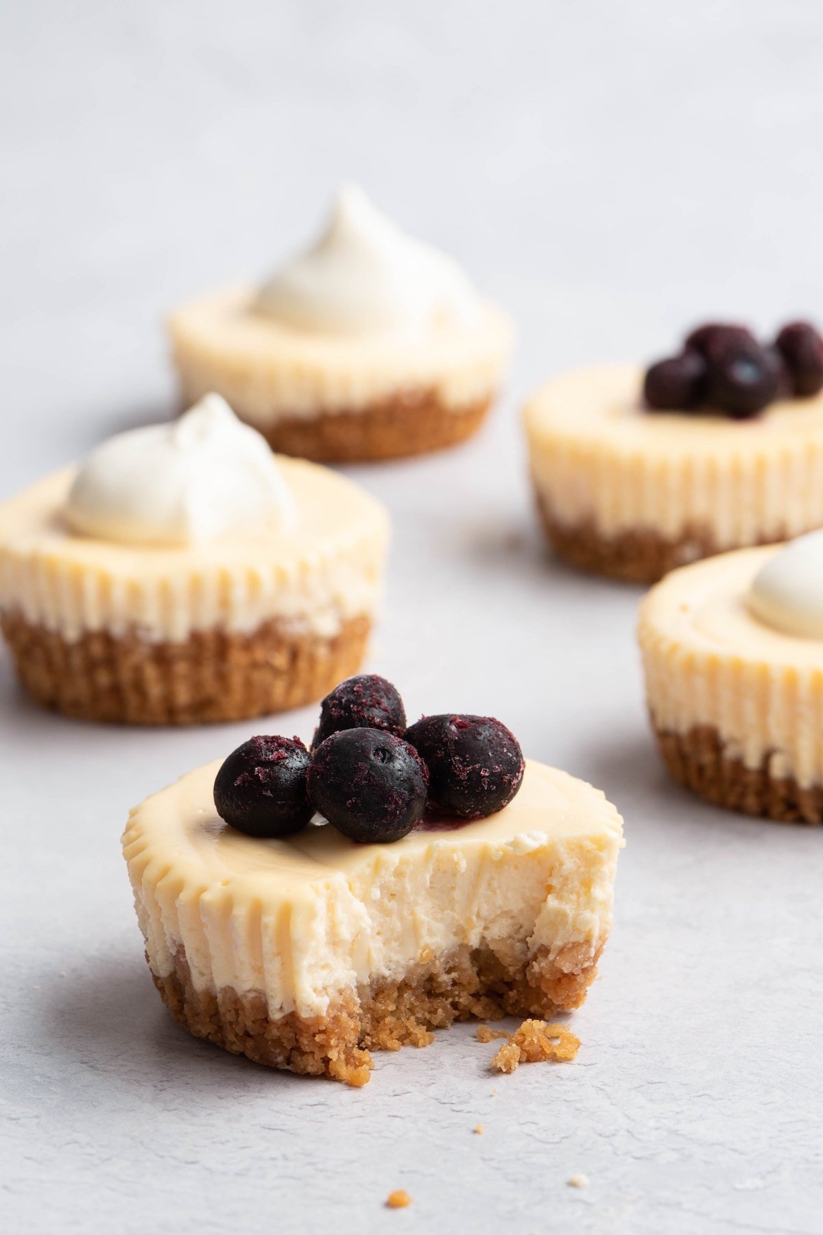 cheesecake cupcake with blueberries on top.