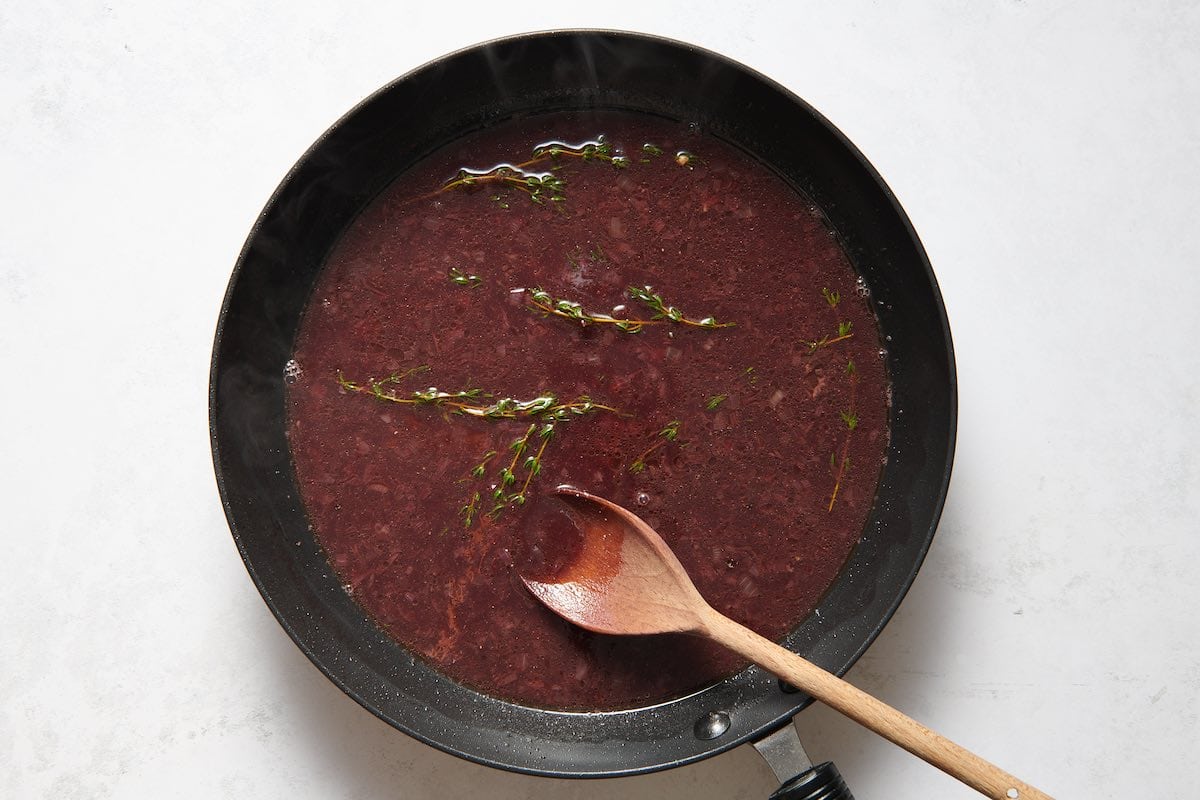 red wine reduction in saucepan.