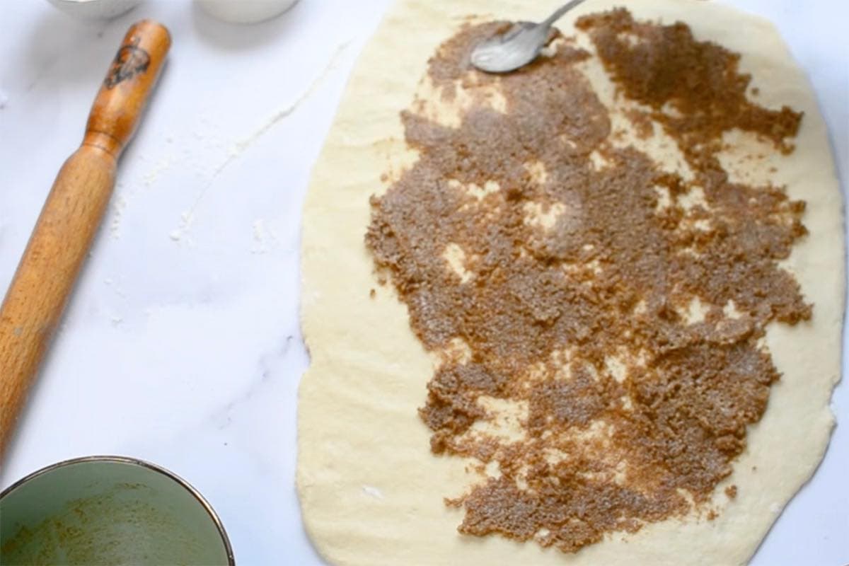 rolled out dough with cinnamon, sugar, and butter.